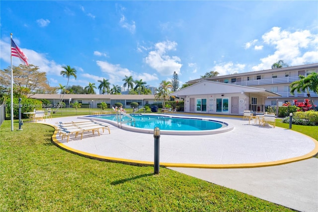 view of pool with a yard and a patio area