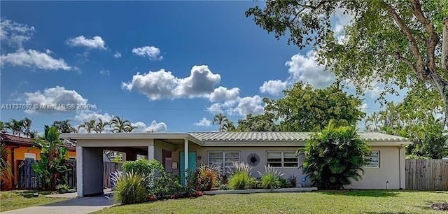 single story home featuring a carport and a front lawn