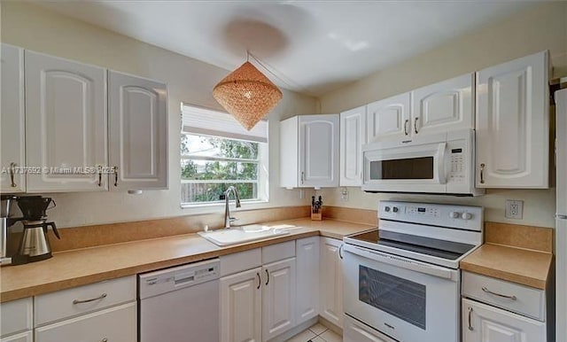 kitchen featuring white cabinetry, white appliances, and sink