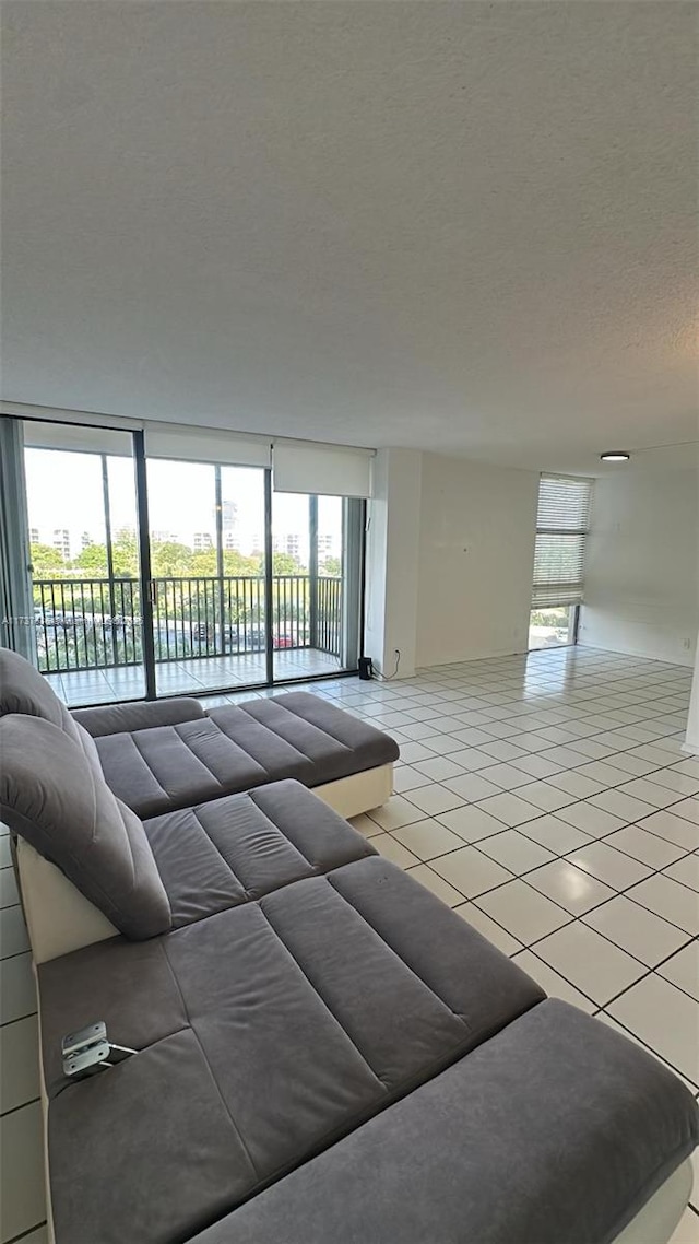 living room with light tile patterned flooring and a textured ceiling