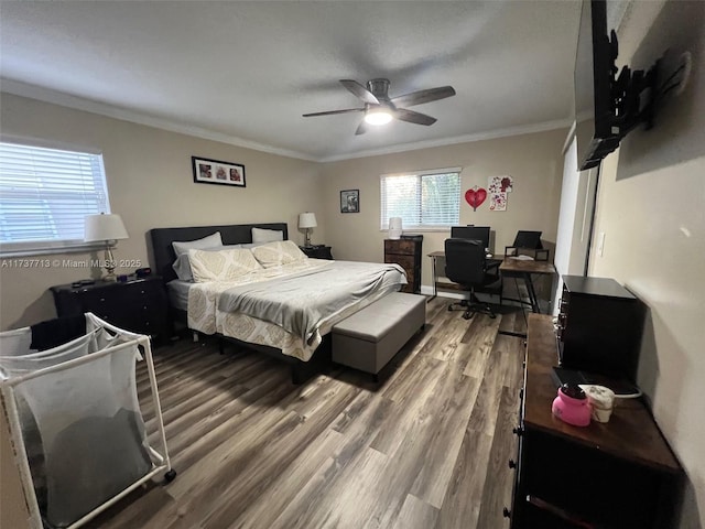 bedroom with hardwood / wood-style floors, crown molding, and ceiling fan