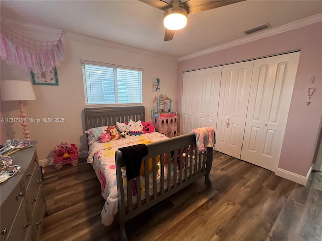 bedroom with crown molding, dark hardwood / wood-style floors, ceiling fan, and a closet