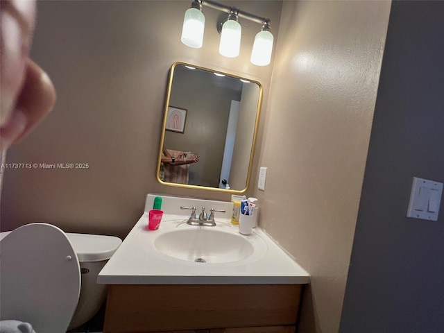 bathroom featuring vanity and toilet