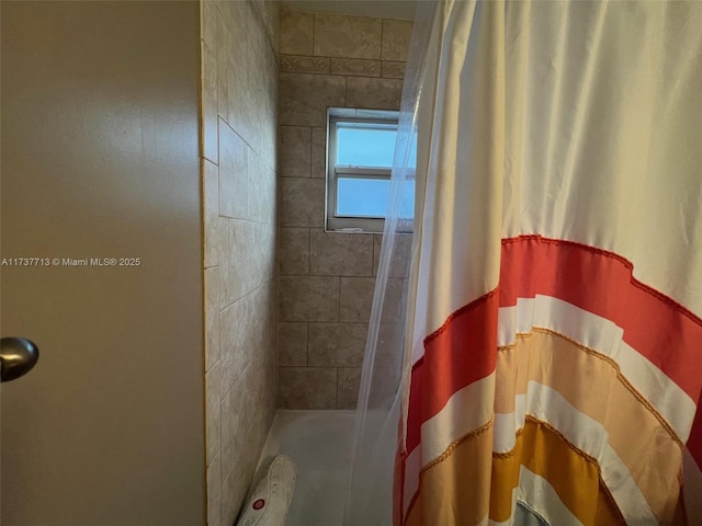 bathroom with a shower with curtain