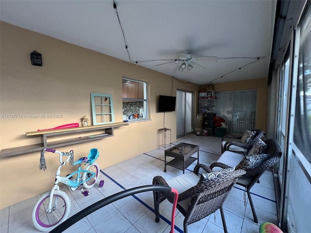 interior space with light tile patterned floors and ceiling fan