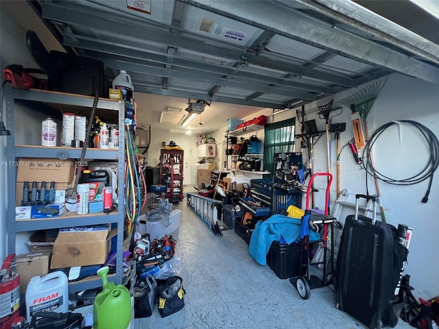 garage featuring a garage door opener and a workshop area