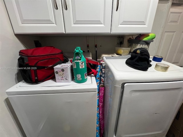 laundry room featuring cabinets and separate washer and dryer