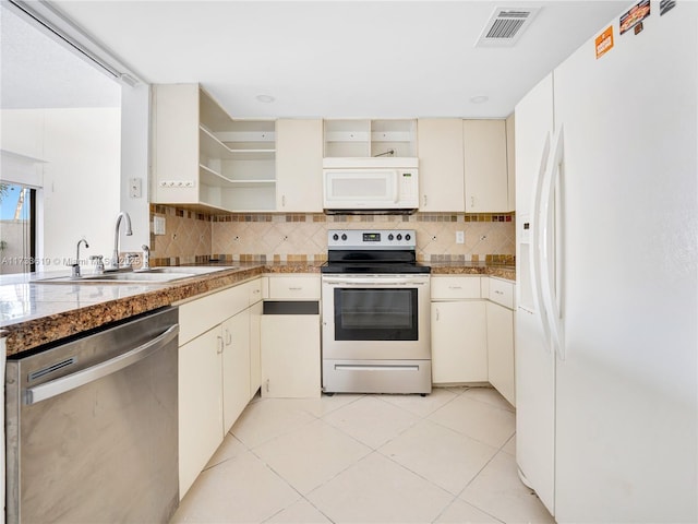 kitchen featuring tasteful backsplash, visible vents, stainless steel appliances, open shelves, and a sink