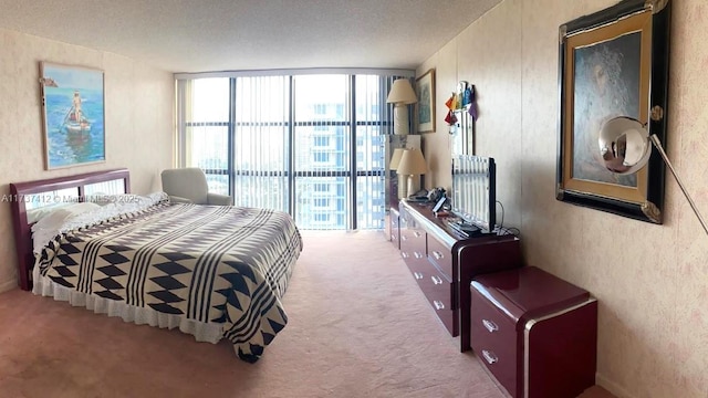 bedroom with a wall of windows and carpet flooring