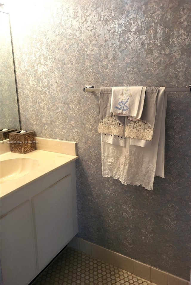 bathroom with tile patterned flooring, vanity, and baseboards