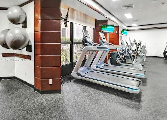 exercise room featuring visible vents and baseboards