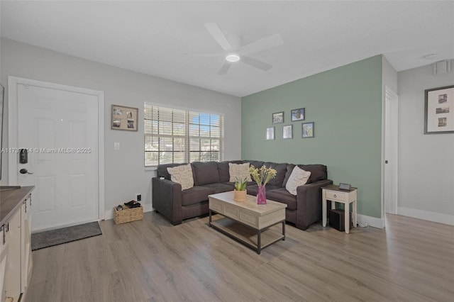 living room with ceiling fan and light wood-type flooring