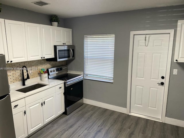 kitchen featuring stainless steel appliances, sink, and white cabinets