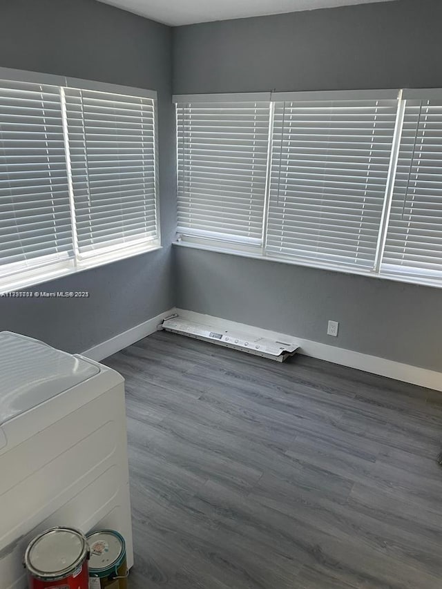 spare room with dark hardwood / wood-style flooring