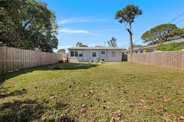 rear view of house featuring a yard