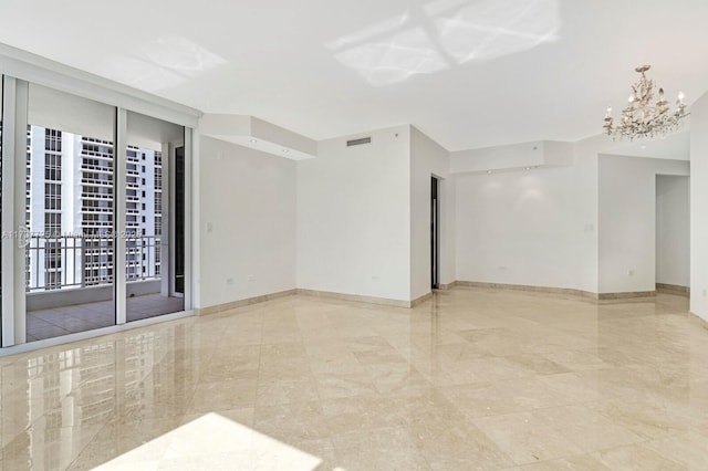 spare room with floor to ceiling windows and a notable chandelier