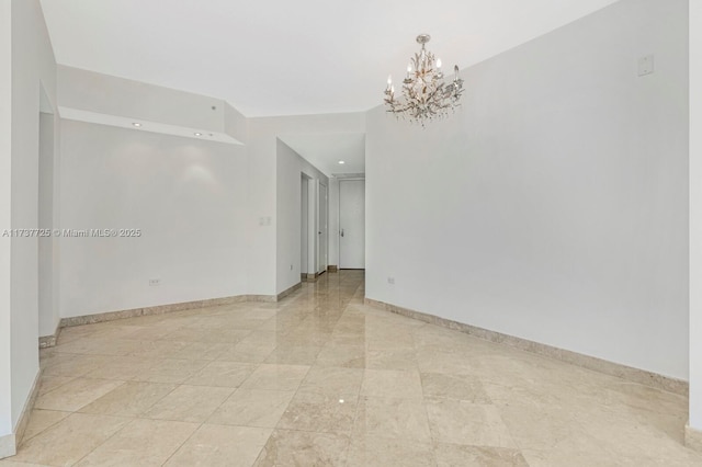 empty room featuring a notable chandelier