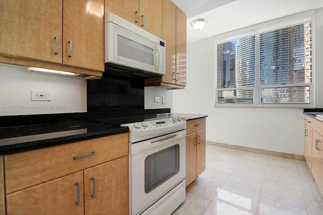 kitchen featuring light tile patterned floors and white appliances