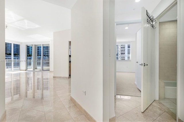 corridor with light tile patterned floors