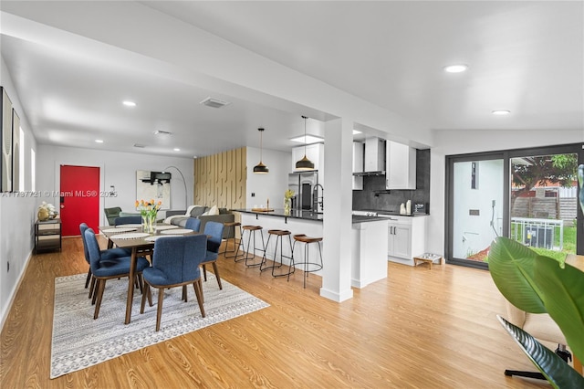 dining room with sink and light hardwood / wood-style floors