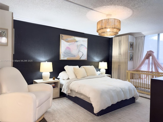 bedroom featuring a textured ceiling and a textured wall