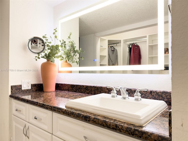 bathroom with a textured ceiling and vanity