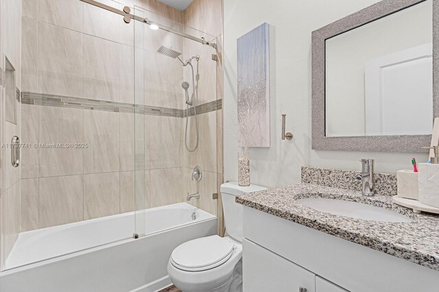 full bathroom with hardwood / wood-style flooring, vanity, toilet, and tiled shower / bath combo