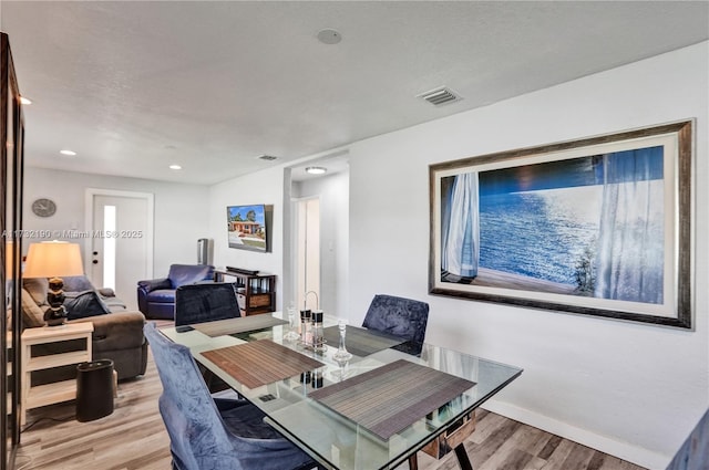 dining space with light hardwood / wood-style flooring