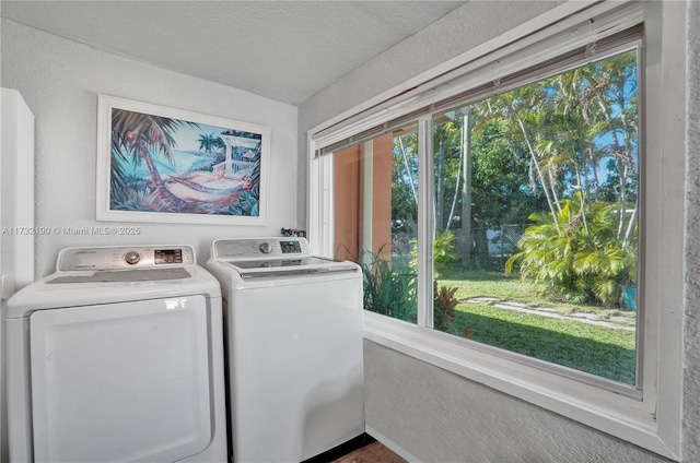 clothes washing area with washing machine and dryer