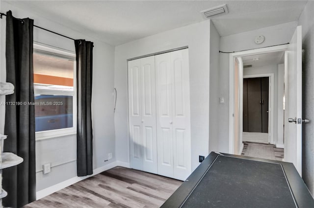 interior space with a closet and light hardwood / wood-style flooring