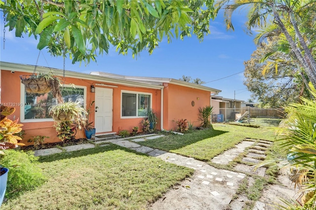 single story home featuring a front yard