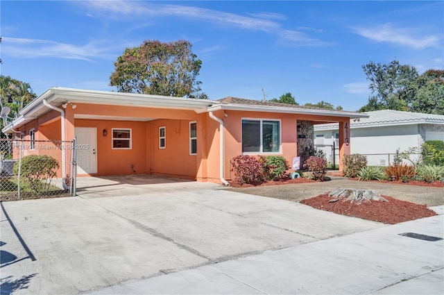 single story home featuring a carport