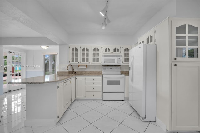 kitchen with white cabinetry, sink, light tile patterned floors, kitchen peninsula, and white appliances