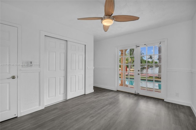 unfurnished bedroom featuring dark hardwood / wood-style floors, a closet, access to outside, ceiling fan, and french doors