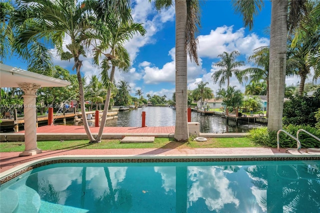 view of swimming pool featuring a water view and a dock