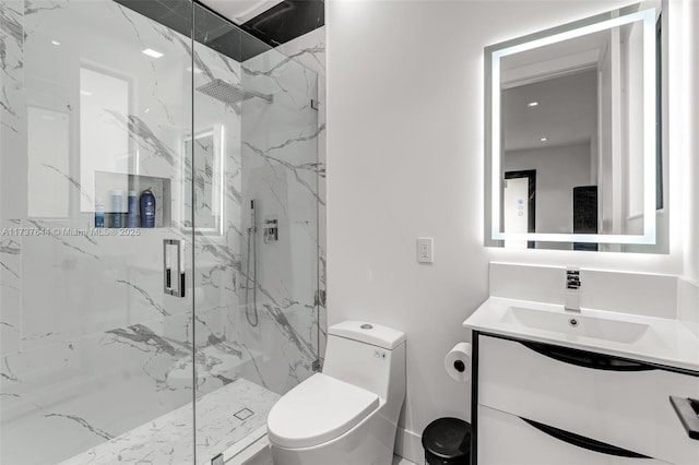 bathroom featuring vanity, a shower with door, and toilet