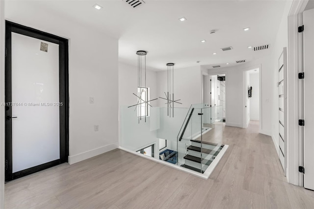 hallway with light hardwood / wood-style flooring