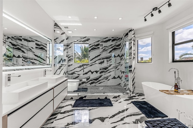 bathroom with vanity, rail lighting, and shower with separate bathtub