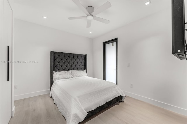 bedroom with light hardwood / wood-style flooring and ceiling fan