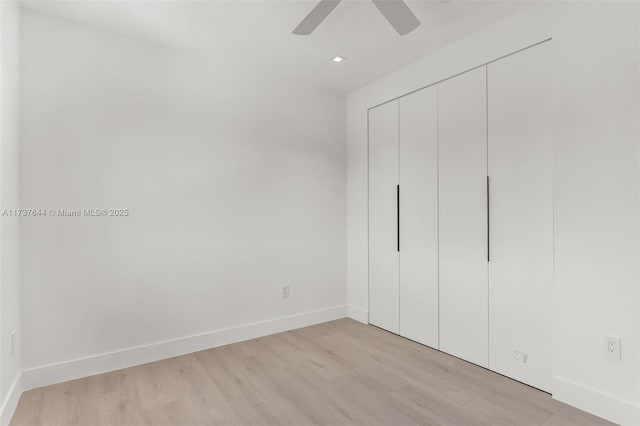 unfurnished bedroom with light hardwood / wood-style floors, a closet, and ceiling fan