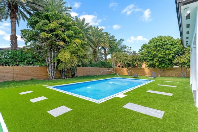 view of pool with a lawn