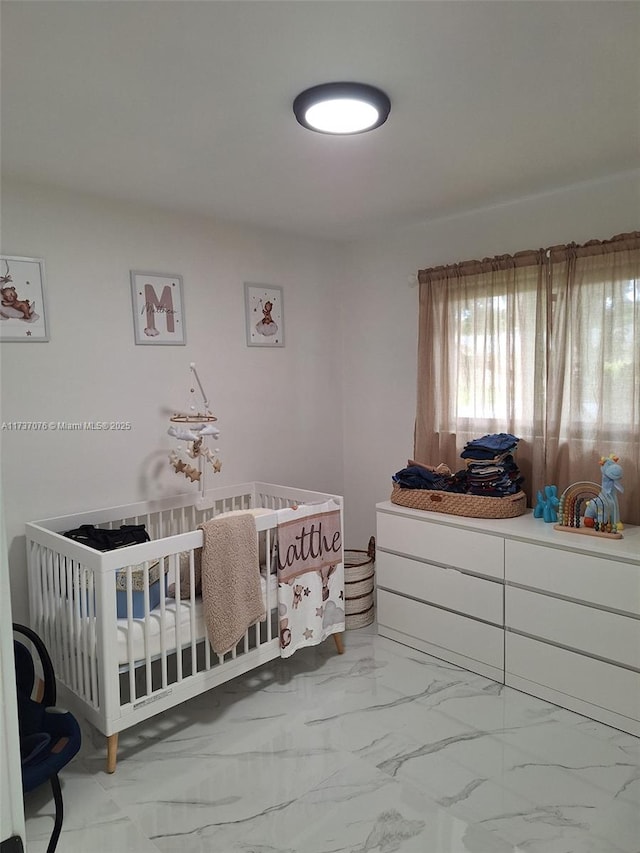 bedroom featuring a nursery area