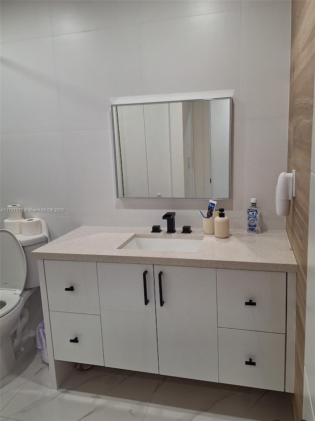 bathroom featuring vanity and toilet