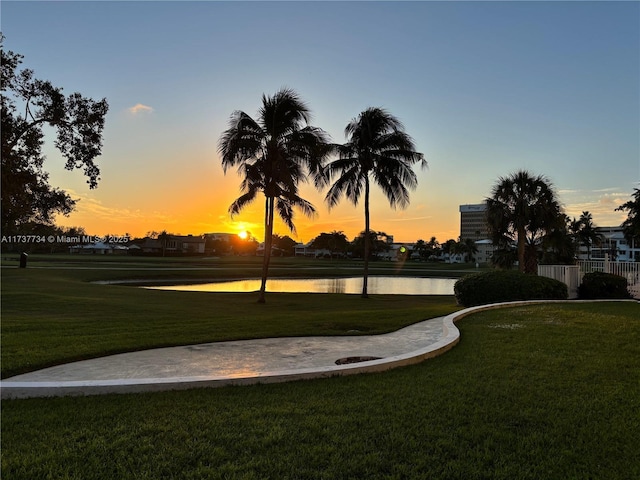 view of property's community with a water view and a yard