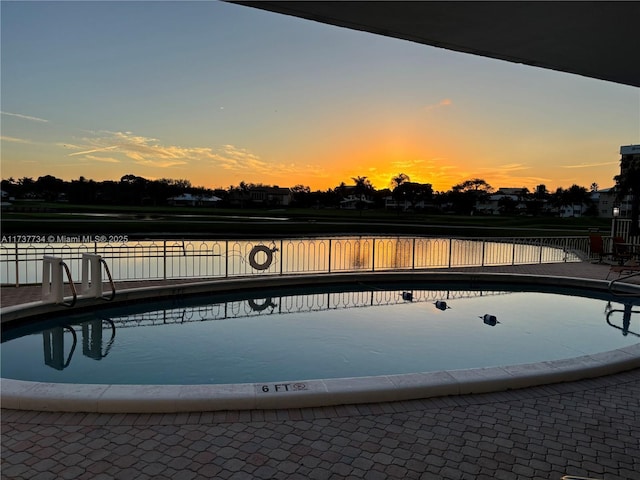 pool at dusk with a water view