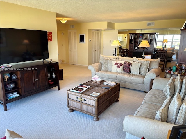 carpeted living room with a textured ceiling