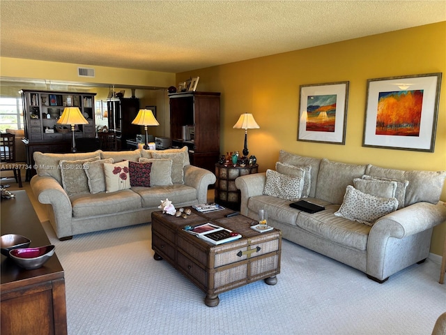 carpeted living room featuring a textured ceiling