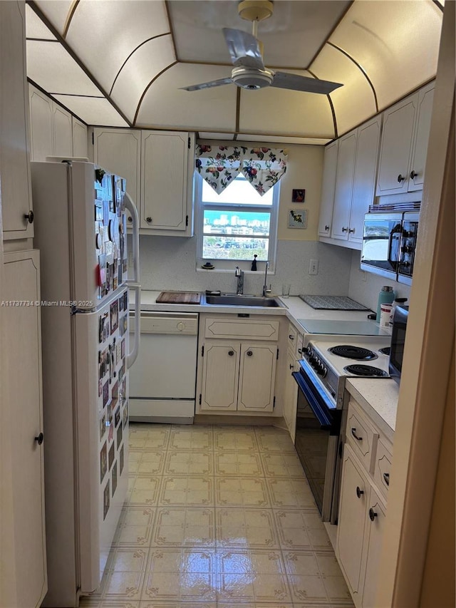 kitchen featuring ceiling fan, white appliances, white cabinetry, and sink