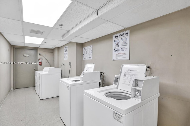 clothes washing area featuring separate washer and dryer