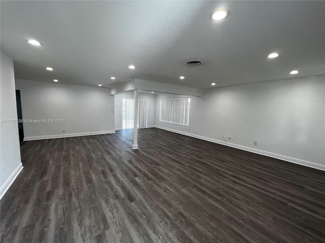 spare room featuring dark wood-type flooring